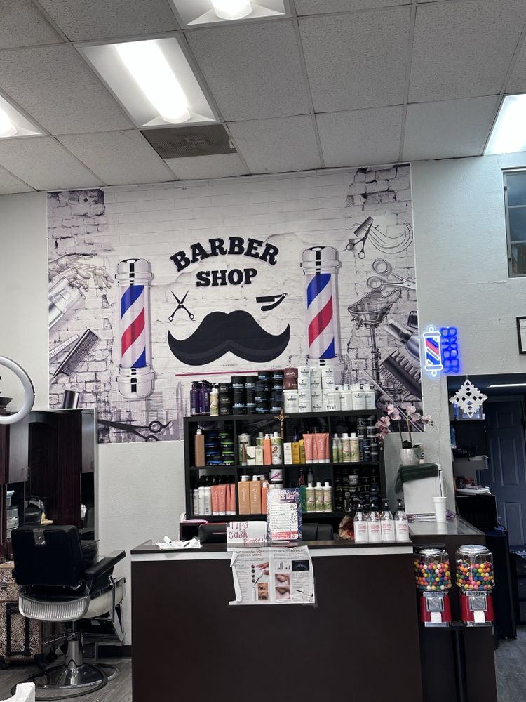 Inside Lexo's Barber Studio, with the barber pole mural behind the front counter